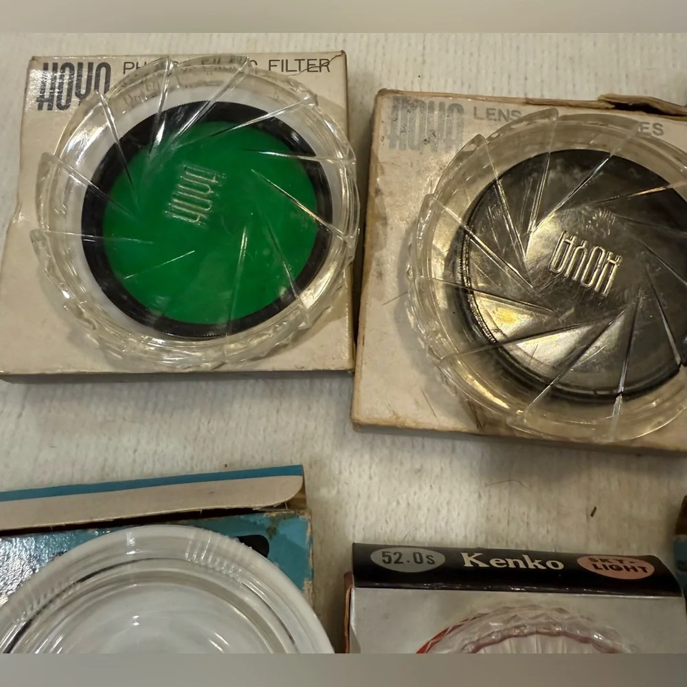 Lot of 4 Hoya photographic filters and 4 filter cases.